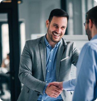 Two men shaking hands, smiling.